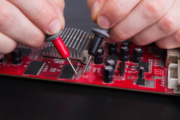 Fototapeta na wymiar Electronic circuit red board inspecting close up