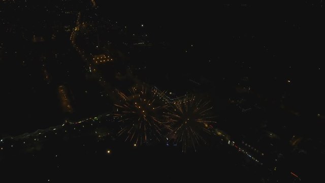 Aerial view Beautiful fireworks video from the drone in the night sky on celebration. Sparks. Fireworks are a class of explosive pyrotechnic devices used for aesthetic and entertainment purposes
