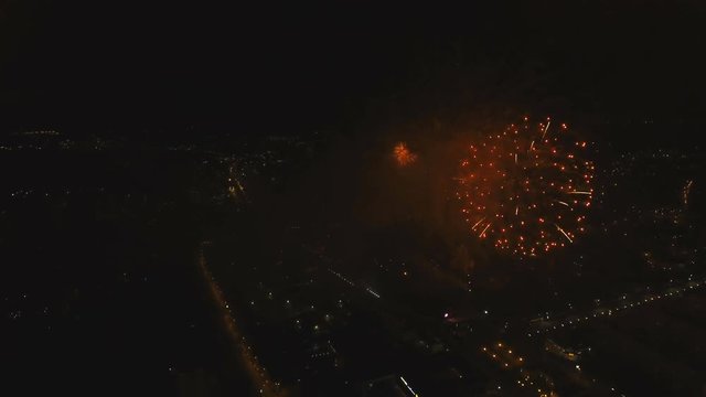 Aerial view Beautiful fireworks video from the drone in the night sky on celebration. Sparks. Fireworks are a class of explosive pyrotechnic devices used for aesthetic and entertainment purposes