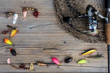 Fishing tackle on a wooden background.