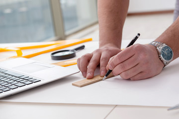 Male engineer working on drawings and blueprints