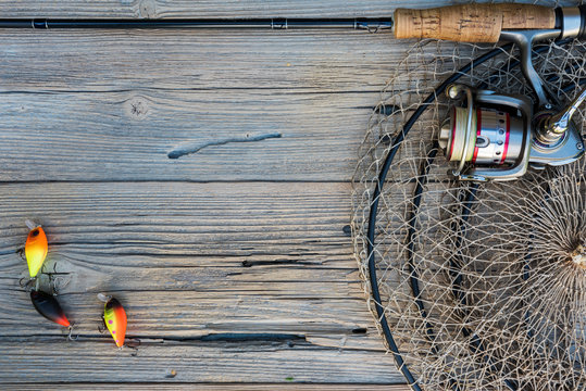 Fishing tackle on a wooden background.