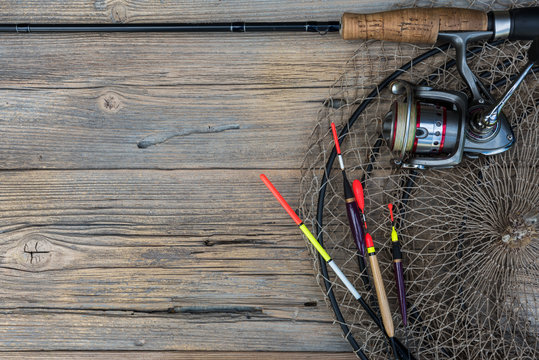 Fishing tackle on a wooden background.