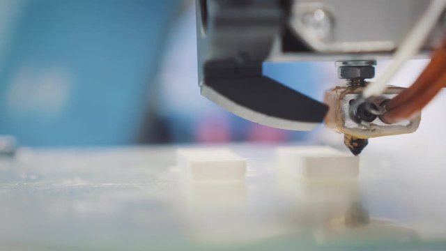 Three dimensional printer during work in school laboratory, 3D plastic printer, 3D printing.