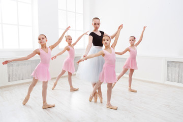 Fototapeta premium Teacher helping her students during dance class