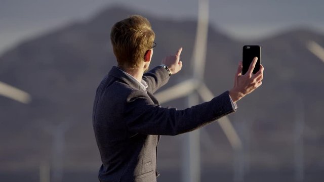 The man through a video call shows the opponent the windmills