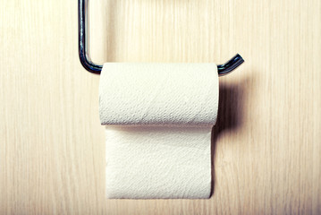 Toilet paper on wood background