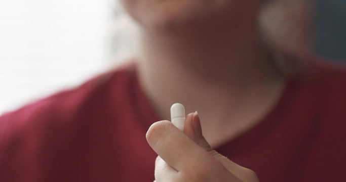 Handheld Teen Girl Taking Pill