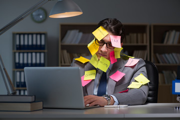 Businessman staying late to sort out priorities