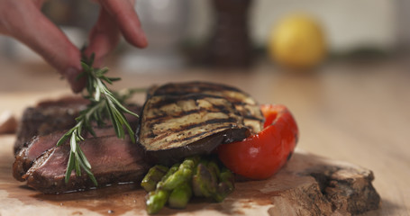 serving medium rib eye steak with rosemary