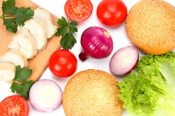 Hamburger Building Kit. round sandwich bun with, tomato, red onion, green lettuce, grilled chicken fillet isolated on white background. Top view with copy space.