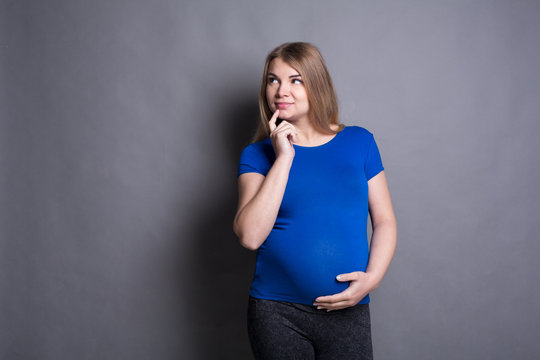 Pensive pregnant woman dreaming about child