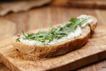 arugula on rustic bread with ricotta cheese