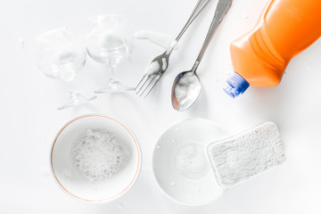 Fototapeta na wymiar Dishwashing liquid, sponge and tableware on white background top view