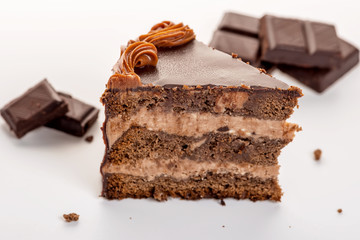 delicious chocolate cake with chocolate broken isolated on white, close up