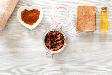 Organic coffee soap, ground coffee, coffee grains, oil on wooden background top view