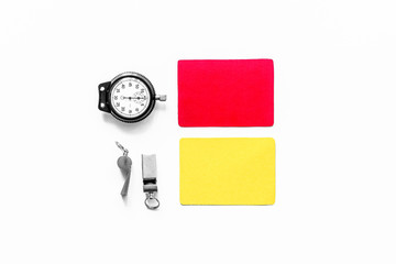 Referee tools. Yellow and red cards, stopwatch, whistle on white background top view copyspace