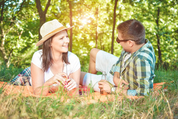 Happy Smiling Couple Relaxing in a Park Picnic