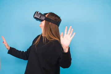 Happy young woman using a virtual reality headset.