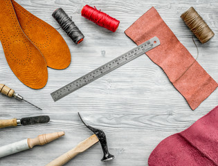 Work desk of clobber. Skin and tools on grey wooden desk background top view copyspace