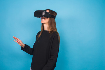 Happy young woman using a virtual reality headset.