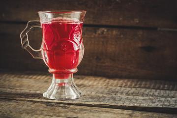 Red juice in a transparent glass with a handle