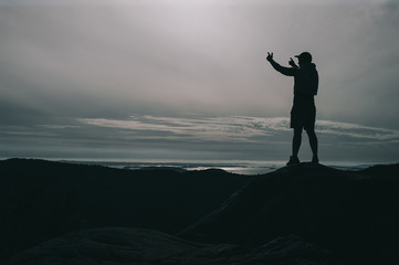 Fototapeta premium A lonely guy stands on a stone in norway