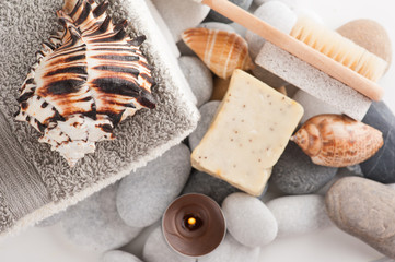 Spa composition with towels, lit candle, soap