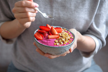 Breakfast smoothie bowl in hands