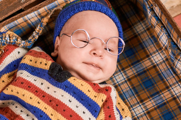 Baby wearing spectacles. Face of a small child. How to raise smart kid.