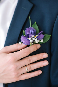 Graceful Stylish Buttonhole Of The Groom From A Iris Closeup.