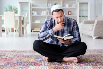 Fototapeta premium Muslim man praying at home