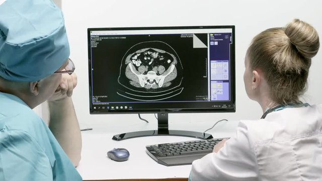 Doctors look at the result of magnetic resonance imaging.