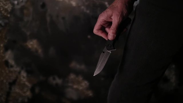 MAN PULLS A KNIFE.  EXTREME CLOSE UP