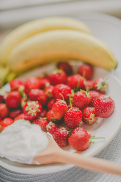 Bunch of bananas and strawberries. Photo toned style Instagram filters. Concept of healthy breakfast
