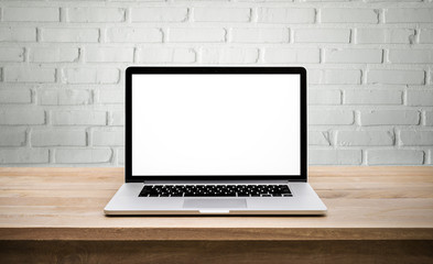 Modern computer,laptop with blank screen on wall brick background