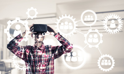 Guy wearing checked shirt and virtual mask demonstrating some em