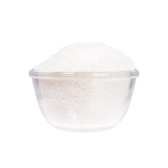 Sea salt in a saucer on white background.