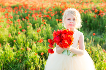 Obraz na płótnie Canvas nature, flora, ecology, future generation, childcare, celebration concept - little cute fair-haired girl with bunny teeth in white party dress holding bouquet of bright red poppies