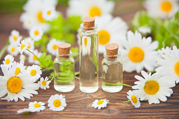 Essence of flowers on table in beautiful glass jar
