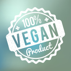 Vegan Product rubber stamp white on a blue bokeh background.