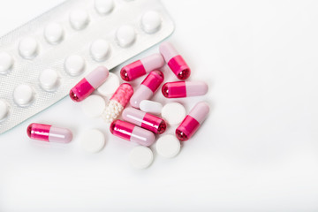 Pile of medical pills and pills on white background.