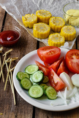 Vegetable salad with corn, tomato, onion and cucumber
