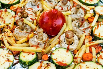 Raw vegetables on the foil before cooking. Close-up.