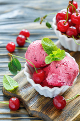 Homemade cherry ice cream in a white bowl.