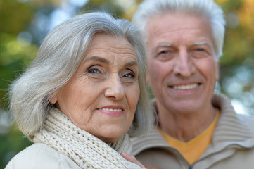  senior couple posing   in the park