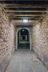 Fototapeta na wymiar Strait tunnel very lonely in the oldest part of the city in Venice, Italy