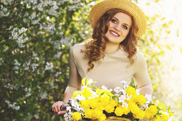 Happy and beautiful. Portrait of young and attractive woman in dress and hat looking to camera and...