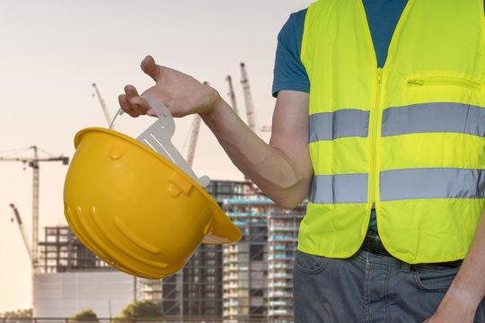 Worker with protective helmet on construction site.