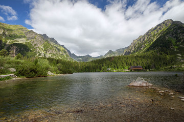 Naklejka na ściany i meble The landscape of the picturesque lake Popradske pond surrounded by mountain peaks.